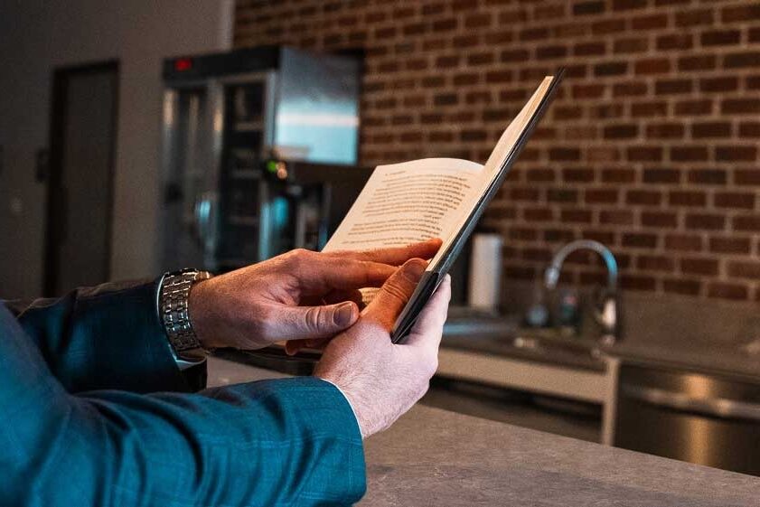 Author reviewing a printed copy of their finished book